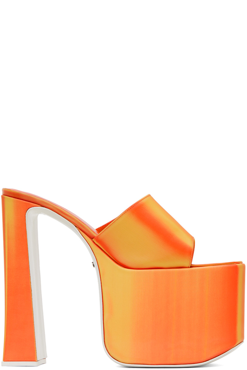 PVC slip-on heeled sandals in orange. Lenticular graphic pattern throughout.

· Open toe
· Fixed strap at vamp
· Logo embossed goatskin footbed
· Covered block heel with rubber injection
· Covered platform midsole
· Logo hardware at leather outsole
· Platform: H3.5 in
· Heel: H6.25 in

Supplier color: Orange