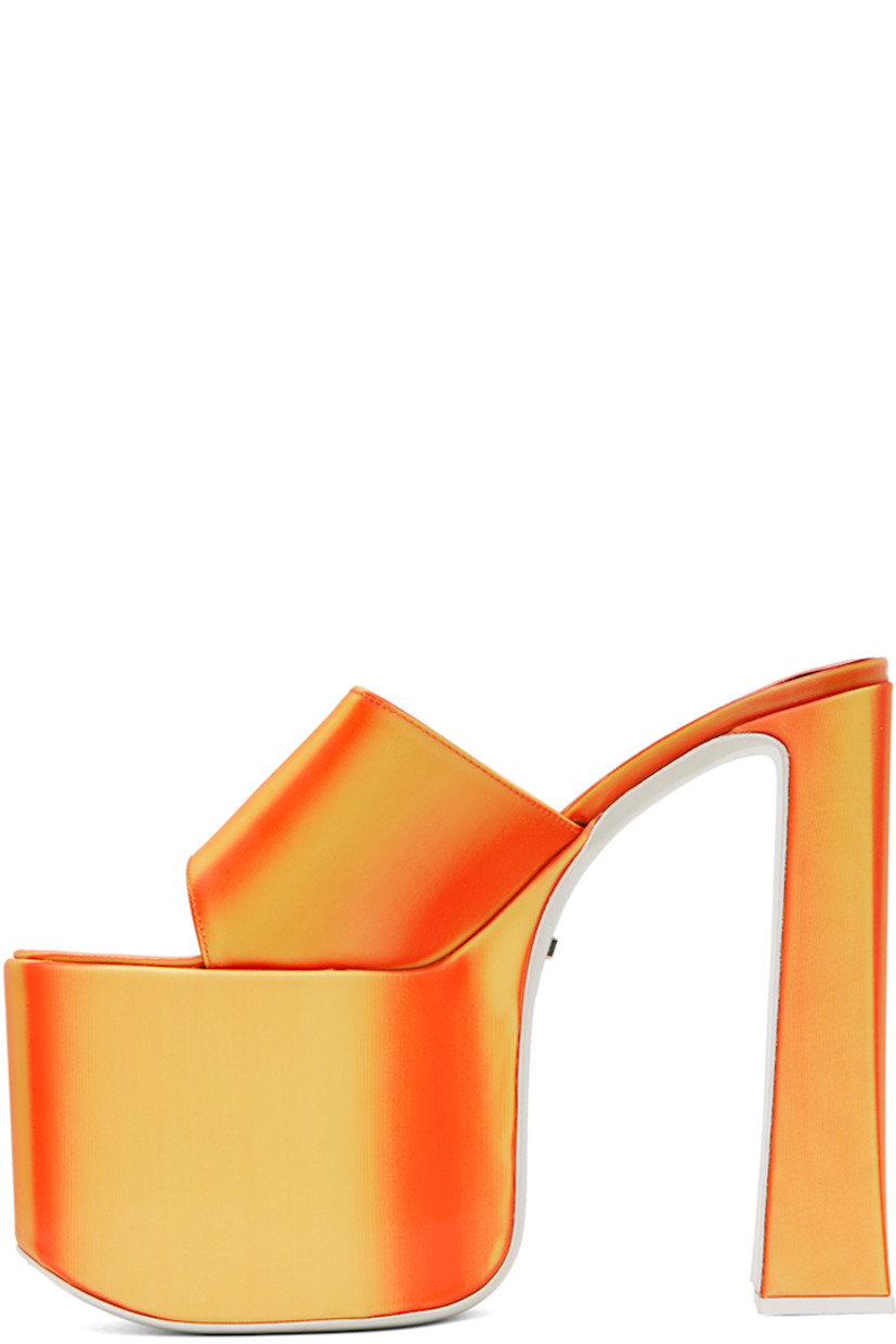 PVC slip-on heeled sandals in orange. Lenticular graphic pattern throughout.

· Open toe
· Fixed strap at vamp
· Logo embossed goatskin footbed
· Covered block heel with rubber injection
· Covered platform midsole
· Logo hardware at leather outsole
· Platform: H3.5 in
· Heel: H6.25 in

Supplier color: Orange