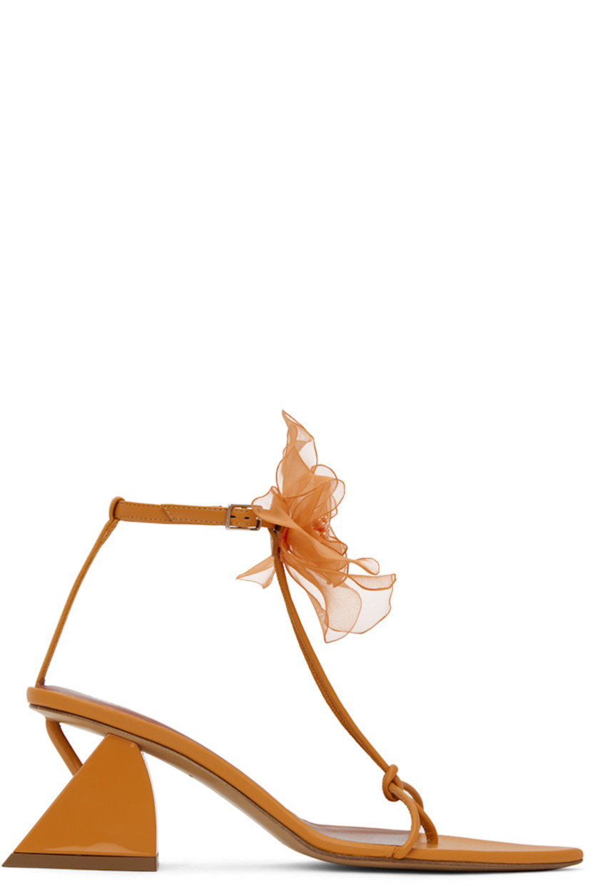 Nappa lambskin heeled sandals in orange. 

· Open pointed toe
· Knotted accent at thong-style strap
· Floral appliqué pin-buckle ankle strap
· Modified block heel with rubber injection
· Leather sole
· Heel: H2.25 in

Supplier color: Orange