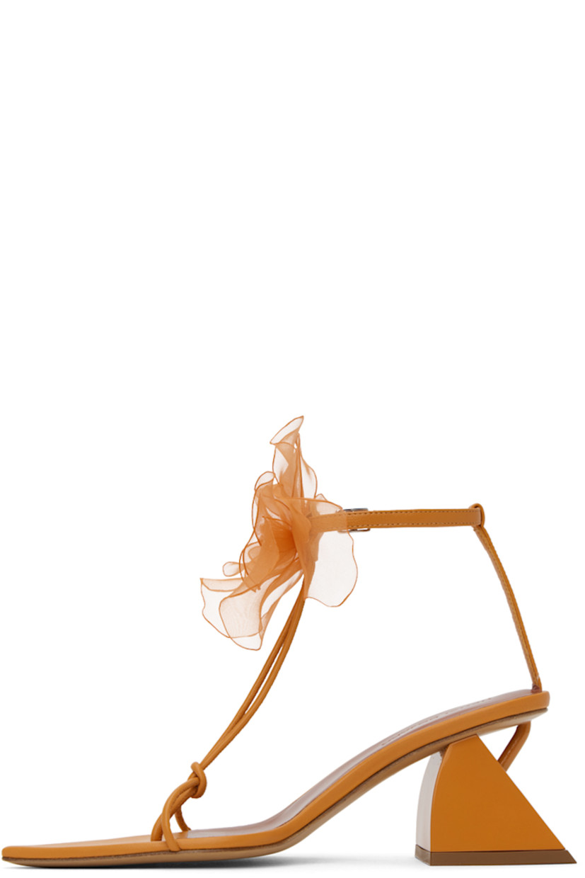 Nappa lambskin heeled sandals in orange. 

· Open pointed toe
· Knotted accent at thong-style strap
· Floral appliqué pin-buckle ankle strap
· Modified block heel with rubber injection
· Leather sole
· Heel: H2.25 in

Supplier color: Orange