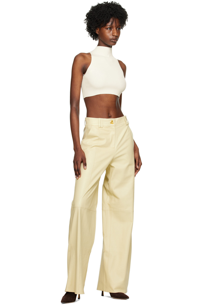 Wide-leg grained chrome-free lambskin trousers. Pinched seams throughout. 

· Paneled construction 
· Belt loops
· Two-pocket styling
· Zip-fly
· Full satin lining
· Graphic gold-tone hardware

Supplier color: Oyster