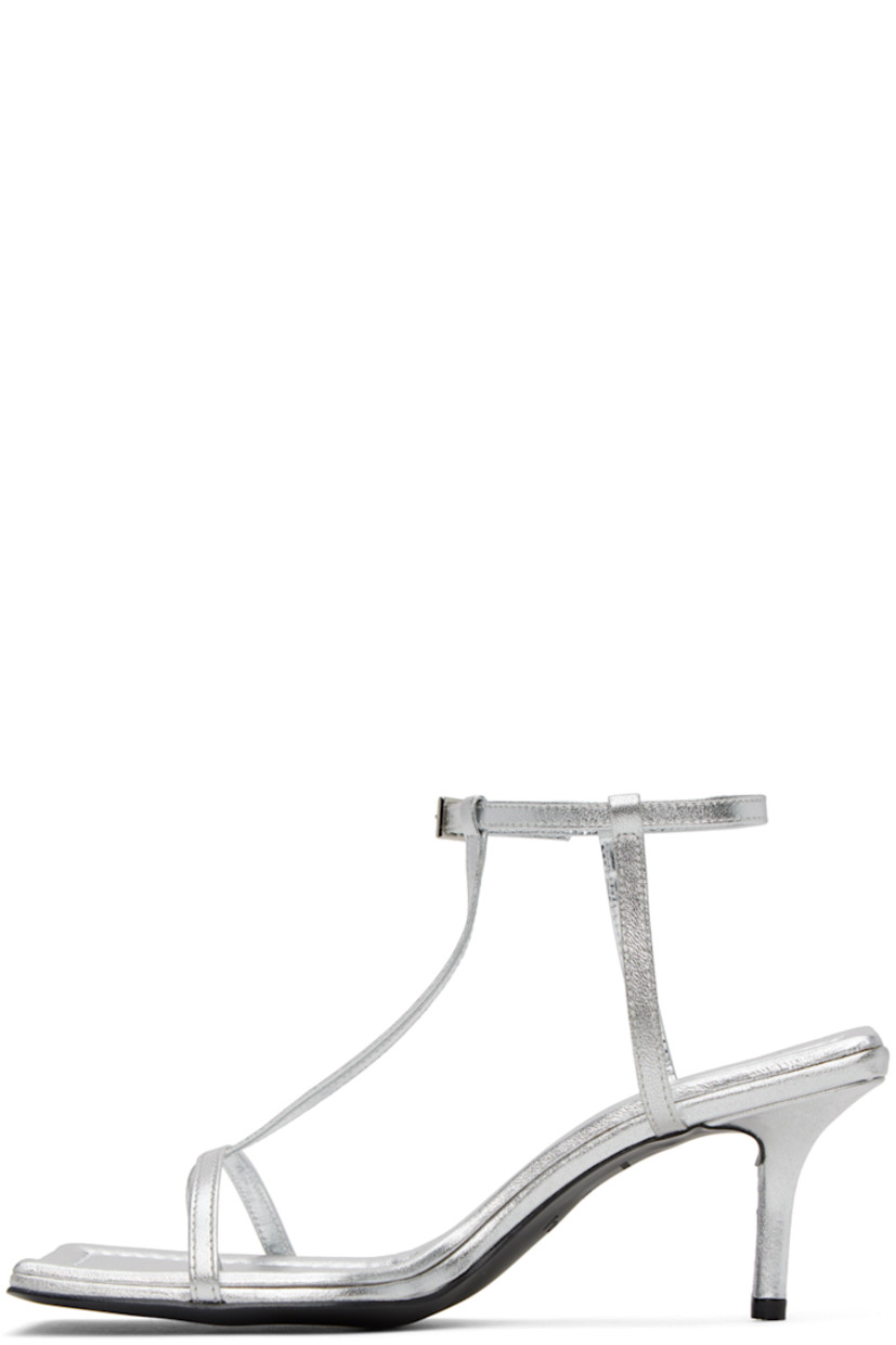 Grained leather heeled sandals in silver-tone.

· Open square toe
· Thong-style strap at vamp
· Pin-buckle ankle strap
· Logo embossed at padded footbed
· Covered kitten heel with rubber injection
· Leather sole
· Heel: H2.5 in

Supplier color: Grey