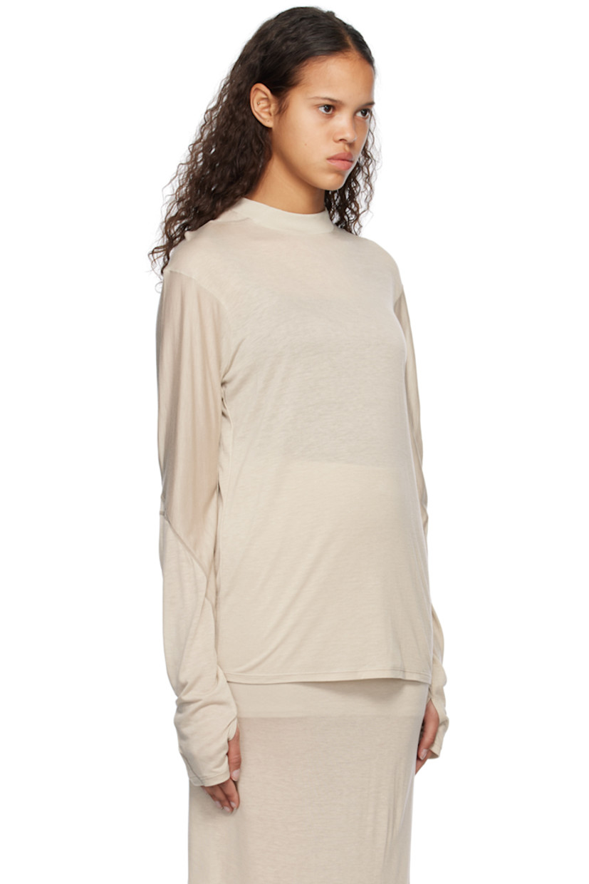 Lightweight semi-sheer lyocell jersey T-shirt.

· Paneled construction
· Rib knit mock neck
· Dropped shoulders
· Thumbhole at cuffs
· Topstitching in gray throughout

Supplier color: Warm grey