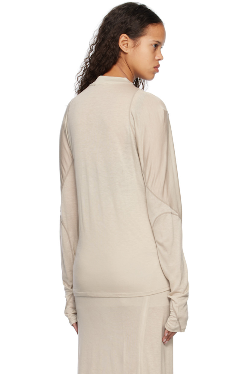 Lightweight semi-sheer lyocell jersey T-shirt.

· Paneled construction
· Rib knit mock neck
· Dropped shoulders
· Thumbhole at cuffs
· Topstitching in gray throughout

Supplier color: Warm grey