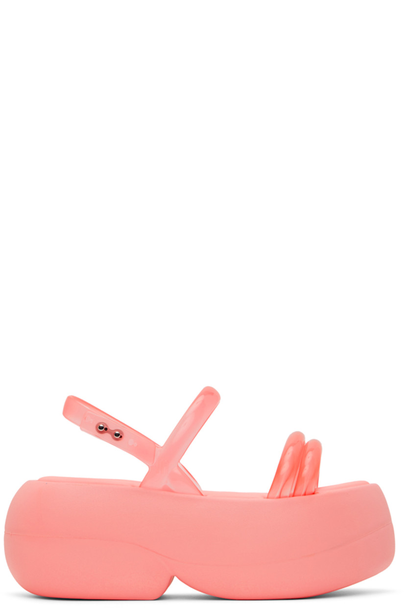 Transparent Melflex® PVC sandals in pink.

· Open round toe
· Padded straps at vamp
· Adjustable slingback strap
· Grenflex® padded rubber footbed
· Treaded EVA foam rubber sole
· Platform: H3 in

Supplier color: Pink