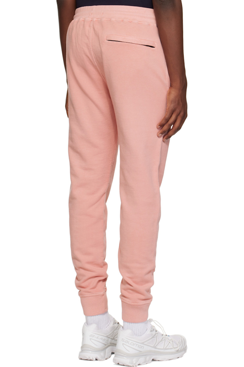 Resist-dyed cotton fleece sweatpants.

· Drawstring at elasticized waistband
· Three-pocket styling
· Mock-fly
· Logo embroidered at front
· Rib knit cuffs

Supplier color: Pale mauve