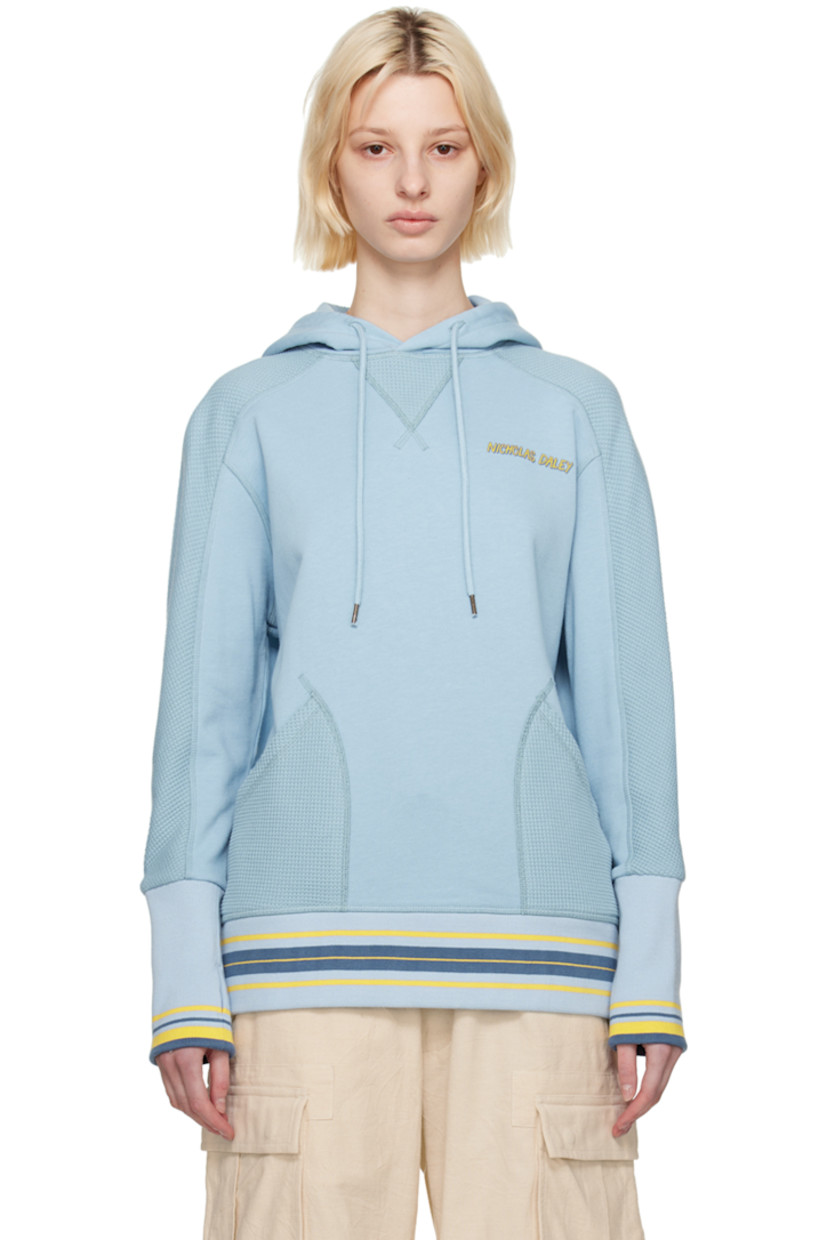 French terry and waffle knit cotton hoodie.

· Drawstring at hood
· Logo printed at chest
· Patch pockets
· Stripes at rib knit hem and cuffs
· Thumbhole at cuffs

Featuring artwork by Kione Granadison.

Supplier color: Powder blue