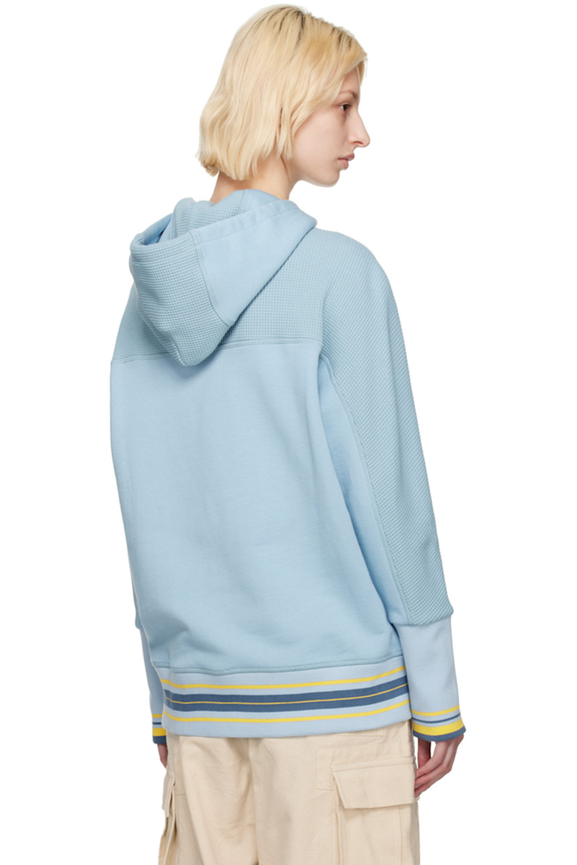 French terry and waffle knit cotton hoodie.

· Drawstring at hood
· Logo printed at chest
· Patch pockets
· Stripes at rib knit hem and cuffs
· Thumbhole at cuffs

Featuring artwork by Kione Granadison.

Supplier color: Powder blue