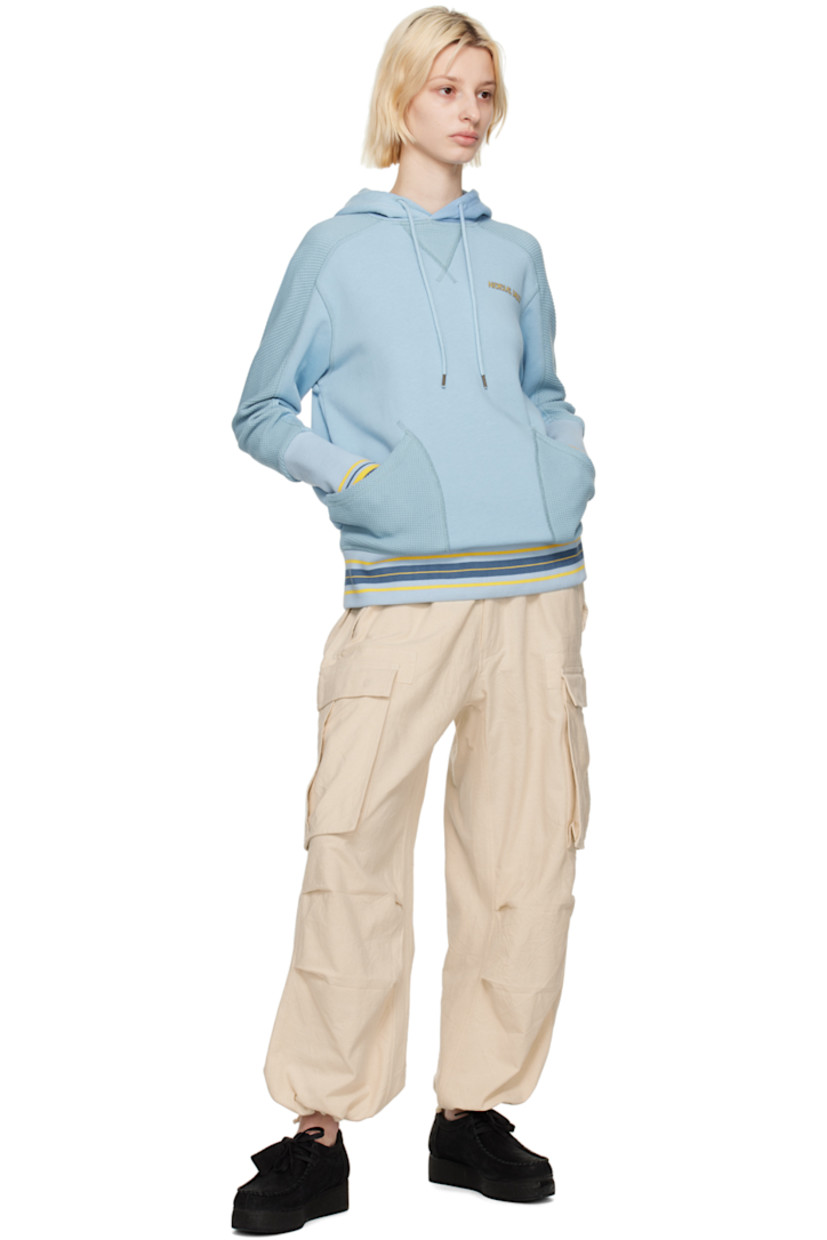 French terry and waffle knit cotton hoodie.

· Drawstring at hood
· Logo printed at chest
· Patch pockets
· Stripes at rib knit hem and cuffs
· Thumbhole at cuffs

Featuring artwork by Kione Granadison.

Supplier color: Powder blue