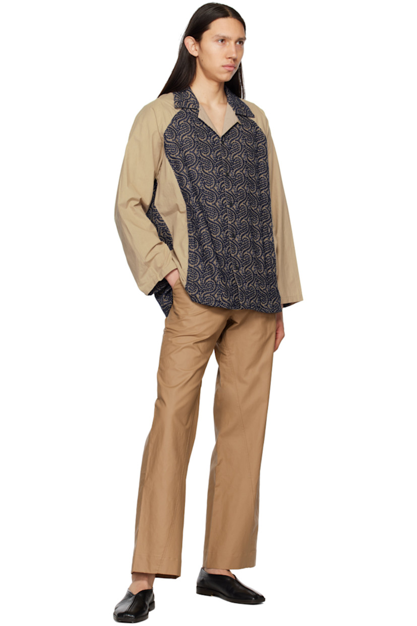 Cotton poplin shirt. Graphic pattern embroidered throughout. 

· Paneled construction 
· Open spread collar 
· Button closure 
· Welt pockets
· Tennis-tail hem 
· Single-button barrel cuffs 

Supplier color: Beige/Navy