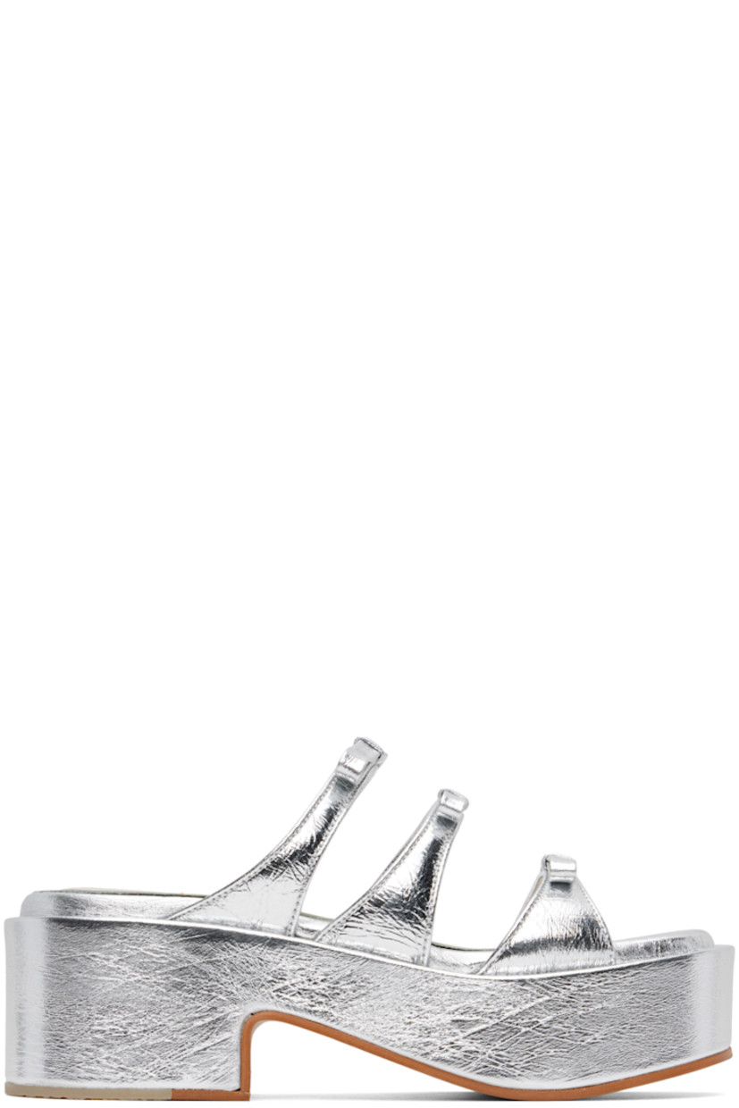 Patent leather slip-on heeled sandals in silver-tone. Crinkling throughout.

· Open square toe
· Straps with bow accents at vamp
· Covered EVA foam rubber platform midsole
· Leather sole with rubber injection at heel
· Platform: H2.25 in

Supplier color: Silver crinkle
