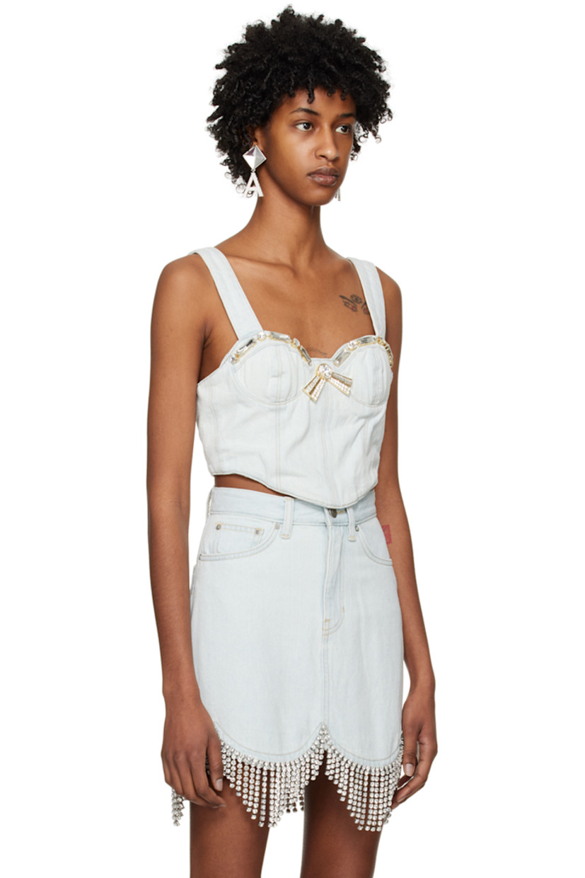 Non-stretch cotton- and recycled cotton-blend denim camisole. Fading throughout. 

· Sweetheart neck 
· Crystal-cut detailing and bow accents at front 
· Adjustable shoulder straps 
· Zip closure at back 
· Full cotton twill lining 
· Logo-engraved antiqued gold-tone hardware 
· Contrast stitching in gold 

Supplier color: Pale blue