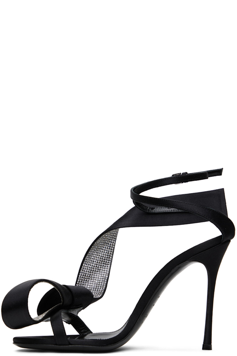 Satin heeled sandals in black. Crystal-cut accents and bow accent at open toe.

· Pin-buckle ankle strap 
· Logo patch at leather footbed
· Covered stiletto heel with rubber injection 
· Leather sole
· Heel: H3.75 in

Part of the Area x Sergio Rossi collaboration.

Supplier color: Black
