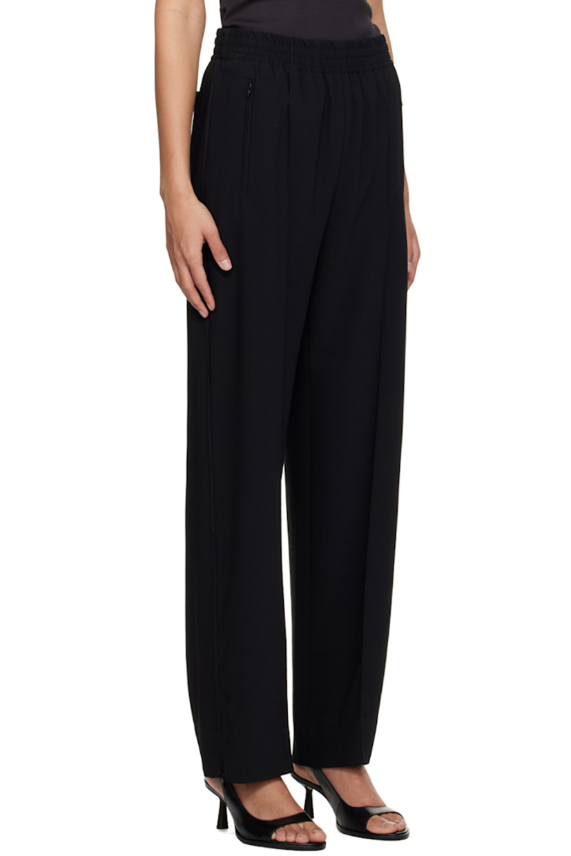 Polyester crepe trousers. 

· Concealed drawstring at elasticized waistband
· Three-pocket styling
· Pinched seams at front 
· Zip vent at cuffs 
· Piping at outseams 

Supplier color: Black