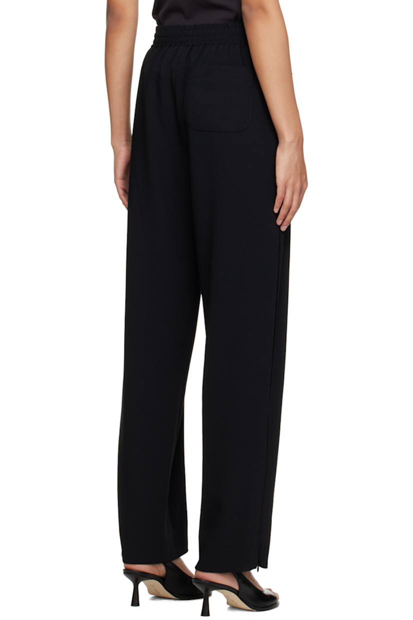 Polyester crepe trousers. 

· Concealed drawstring at elasticized waistband
· Three-pocket styling
· Pinched seams at front 
· Zip vent at cuffs 
· Piping at outseams 

Supplier color: Black