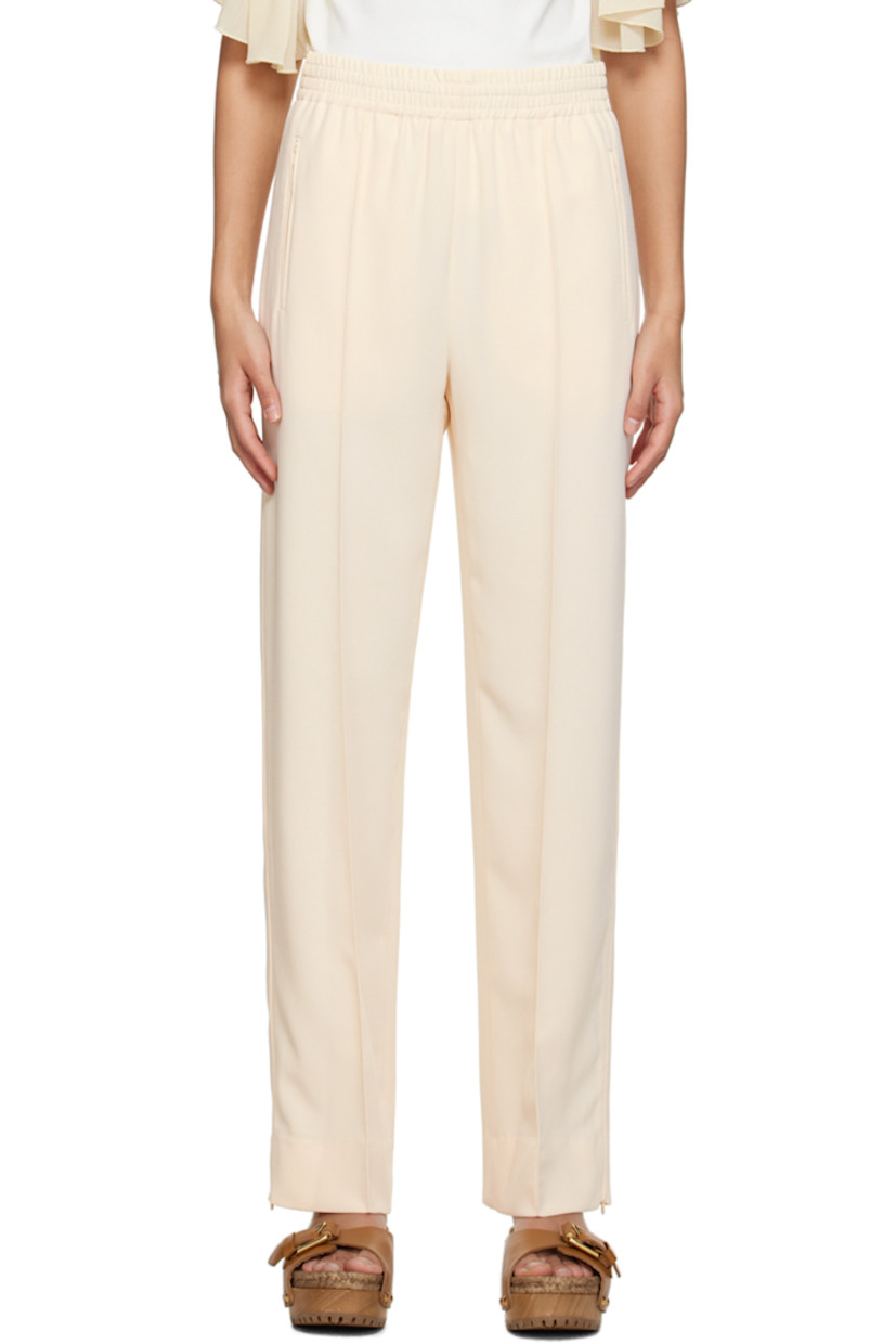 Polyester crepe trousers. 

· Concealed drawstring at elasticized waistband
· Three-pocket styling
· Pinched seams at front 
· Zip vent at cuffs 
· Piping at outseams 

Supplier color: Ivory