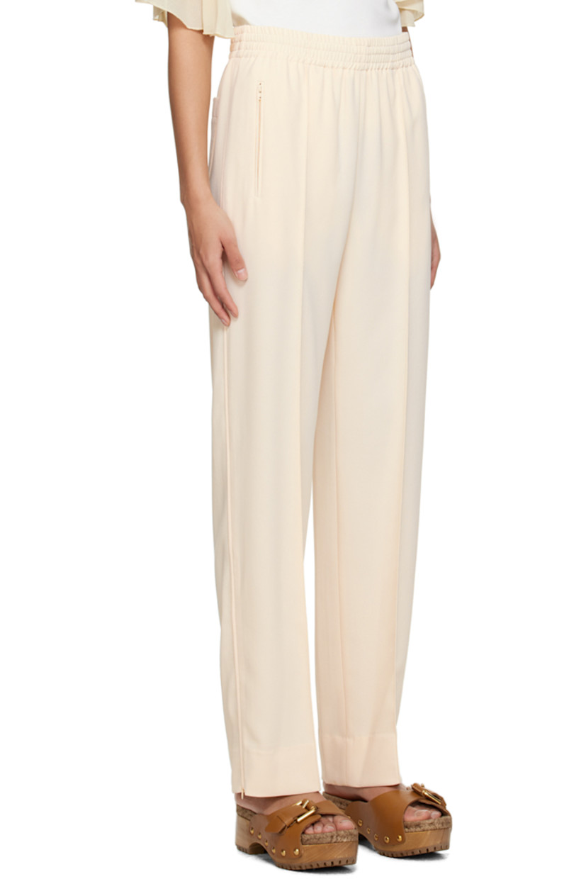 Polyester crepe trousers. 

· Concealed drawstring at elasticized waistband
· Three-pocket styling
· Pinched seams at front 
· Zip vent at cuffs 
· Piping at outseams 

Supplier color: Ivory