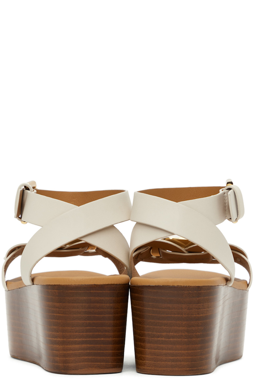 Grained calfskin sandals in white. 

· Open round toe
· Logo-engraved hardware at vamp
· Pin-buckle fastening at ankle strap
· Logo-embossed leather footbed
· Wooden platform midsole and wedge heel
· Rubber outsole 
· Platform: H2.5"

Supplier color: Natural