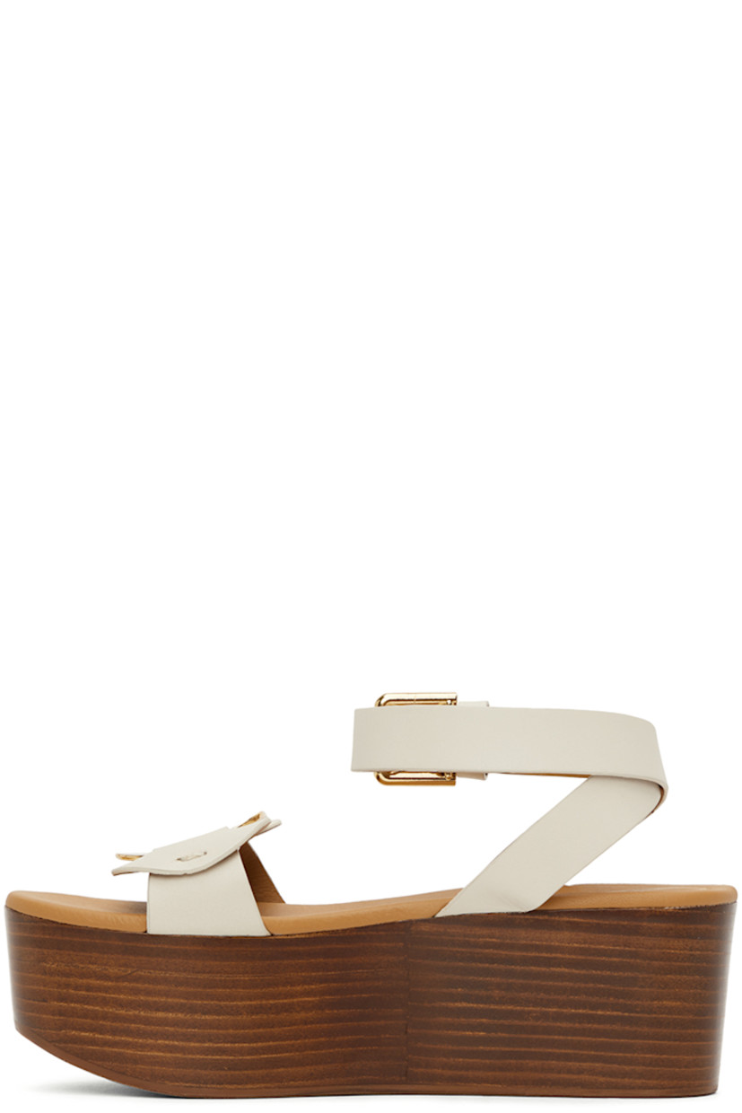 Grained calfskin sandals in white. 

· Open round toe
· Logo-engraved hardware at vamp
· Pin-buckle fastening at ankle strap
· Logo-embossed leather footbed
· Wooden platform midsole and wedge heel
· Rubber outsole 
· Platform: H2.5"

Supplier color: Natural