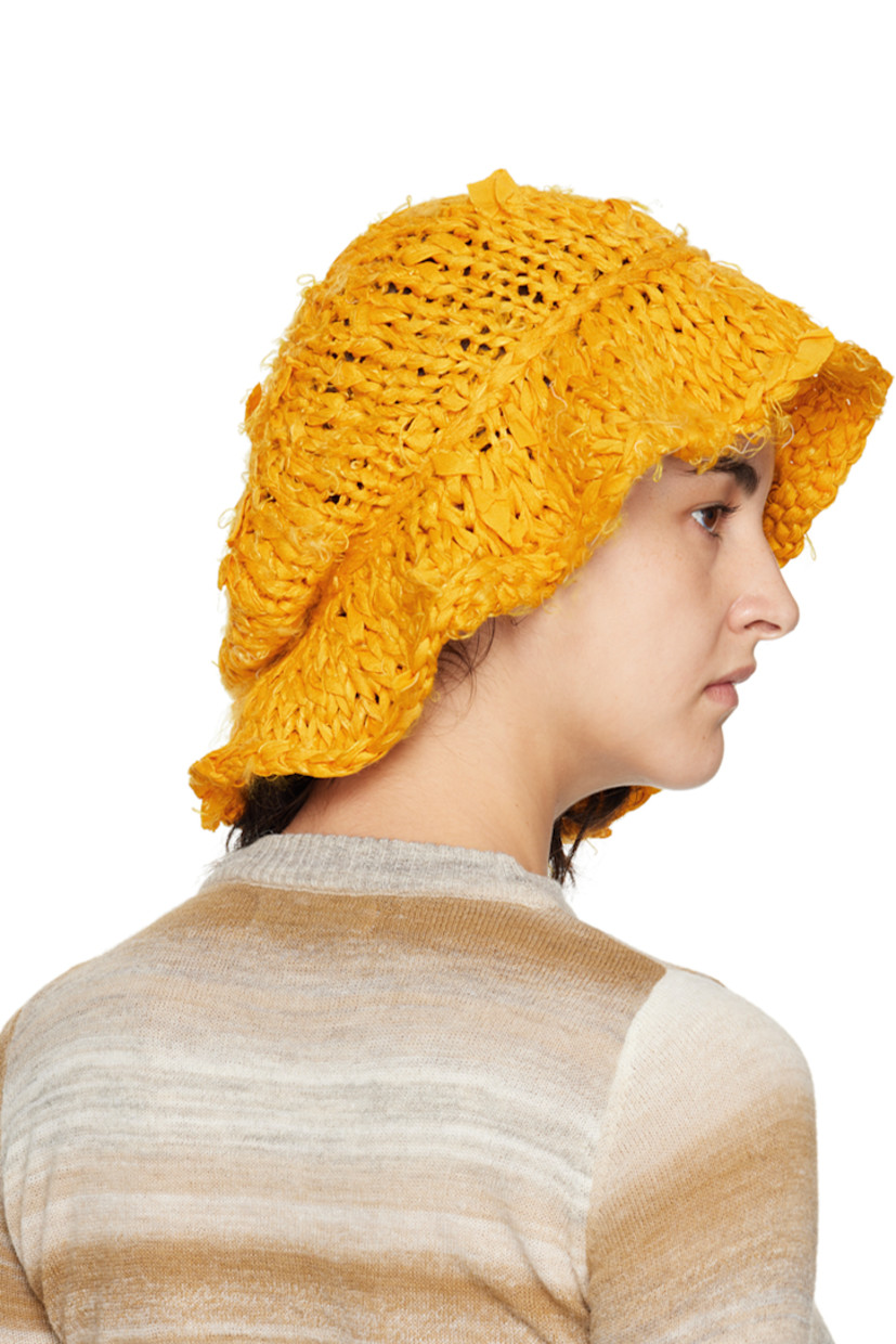 Hand-knit silk bucket hat in yellow. 

· Distressing and loose thread detailing throughout
· Unlined

Each item is unique. Please note that finishings may vary.

Supplier color: Saffron