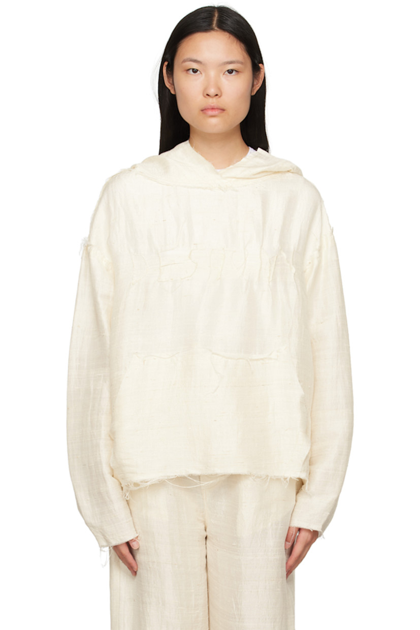 Handcrafted silk khadi hoodie. Raw edges and loose thread detailing throughout.

�· Pinched seam text at front
· Kangaroo pocket

Part of a limited run of 16.

Supplier color: Natural