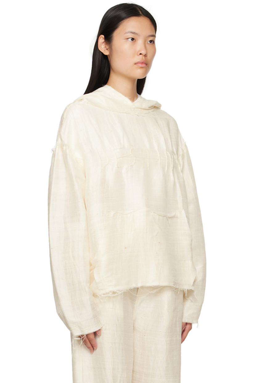 Handcrafted silk khadi hoodie. Raw edges and loose thread detailing throughout.

· Pinched seam text at front
· Kangaroo pocket

Part of a limited run of 16.

Supplier color: Natural