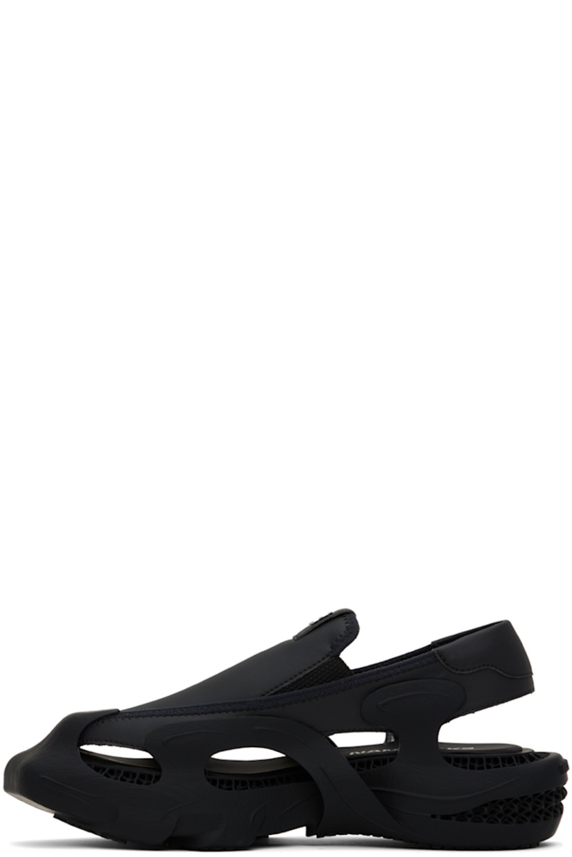 Rubber sandals in black. Cutouts throughout.

· Square rubber cap toe
· Rubberized logo patch at padded vamp
· Elasticized gussets at sides
· Padded slingback strap
· Mesh lining
· Logo printed at padded footbed
· Covered platform rubber midsole
· Treaded rubber sole
· Platform: H2 in

This item is part of a limited run of 100.

Supplier color: Euphoric black