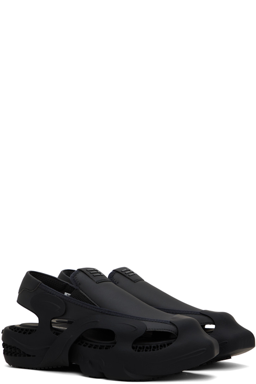 Rubber sandals in black. Cutouts throughout.

· Square rubber cap toe
· Rubberized logo patch at padded vamp
· Elasticized gussets at sides
· Padded slingback strap
· Mesh lining
· Logo printed at padded footbed
· Covered platform rubber midsole
· Treaded rubber sole
· Platform: H2 in

This item is part of a limited run of 100.

Supplier color: Euphoric black