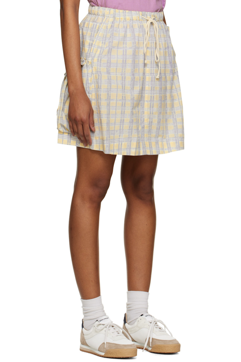 Organic cotton poplin skirt. Check pattern throughout. 

· Drawstring at elasticized waistband 
· Two-pocket styling 
· Patch pockets with drawstring at side seams 

Supplier color: Coast check block