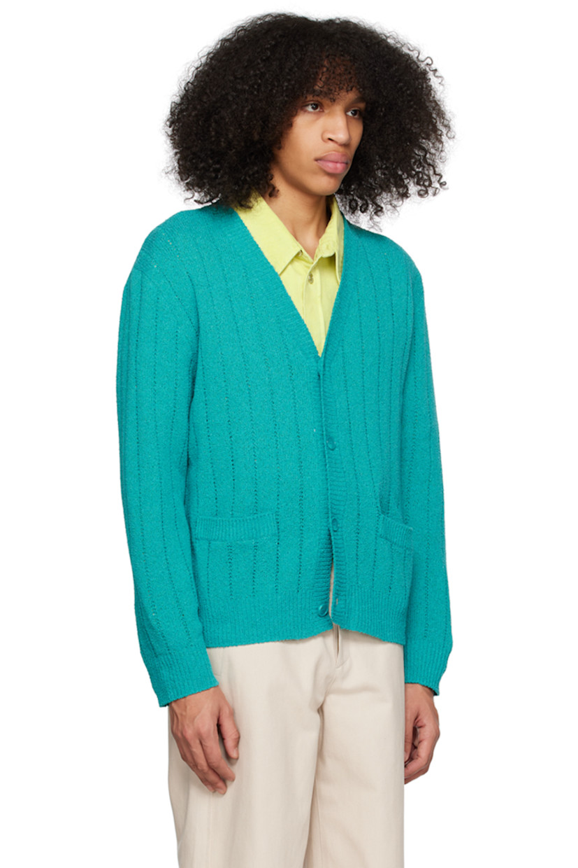 Knit polyester- and cotton-blend bouclé cardigan. Open knit detailing throughout. 

· Rib knit Y-neck, hem, and cuffs
· Patch pockets
· Logo hardware at back collar

Supplier color: Turquoise