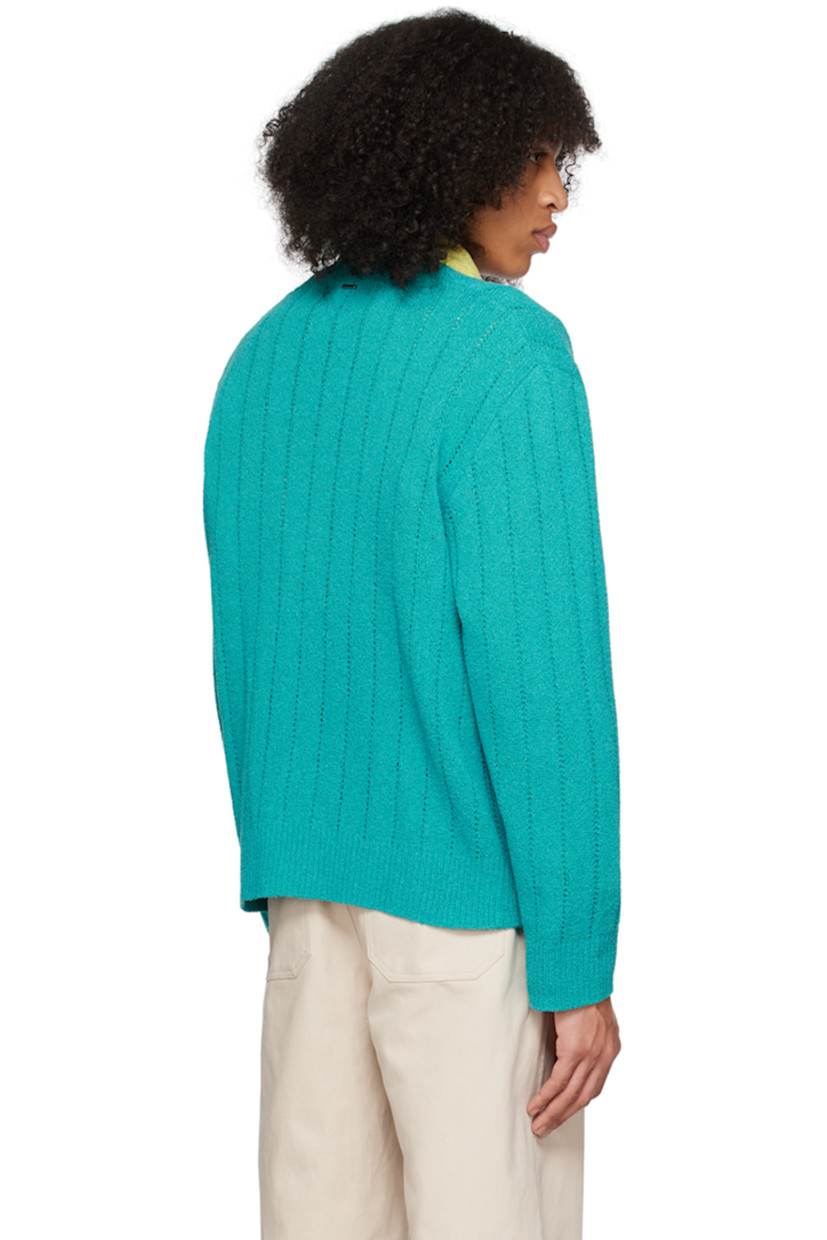 Knit polyester- and cotton-blend bouclé cardigan. Open knit detailing throughout. 

· Rib knit Y-neck, hem, and cuffs
· Patch pockets
· Logo hardware at back collar

Supplier color: Turquoise