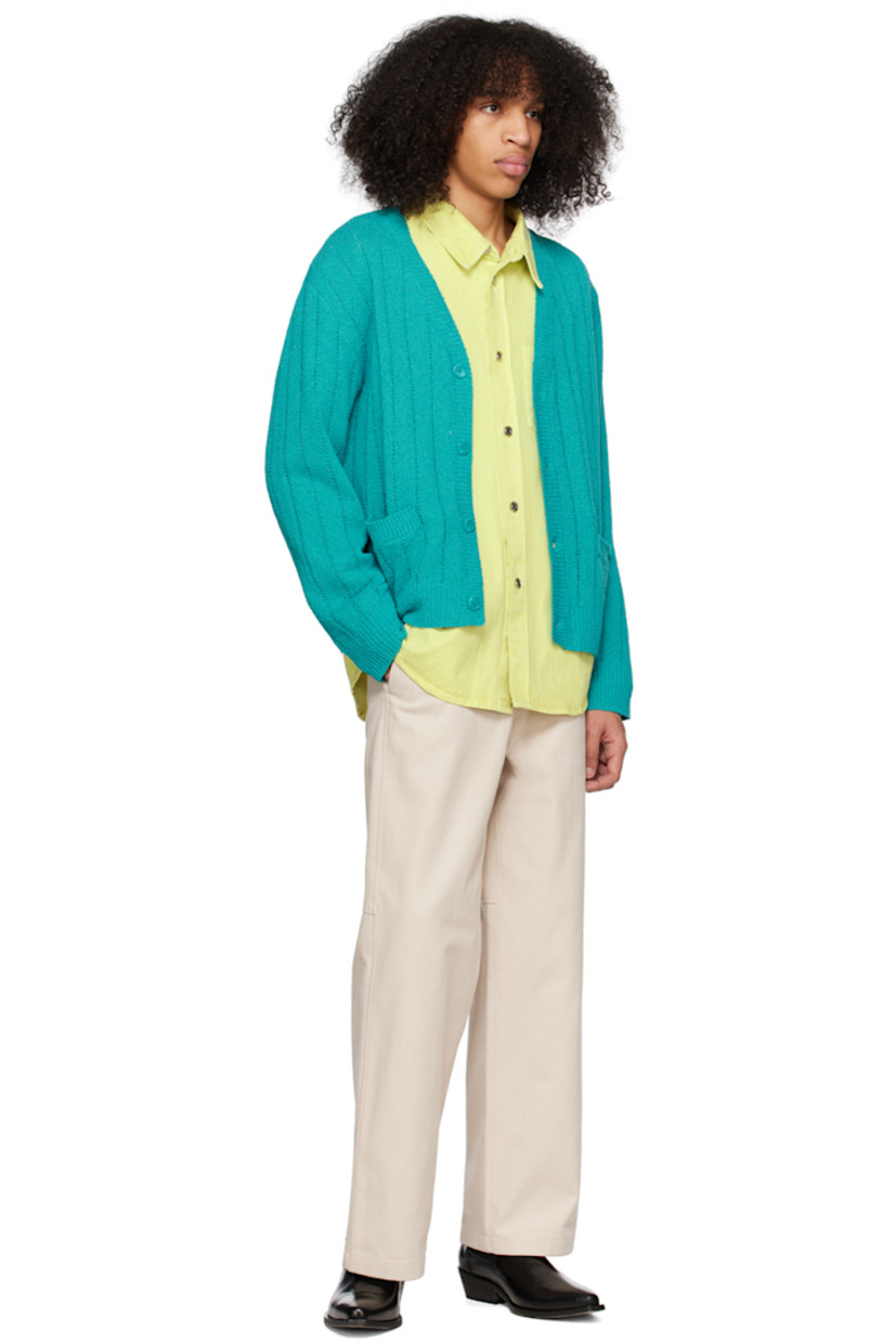 Knit polyester- and cotton-blend bouclé cardigan. Open knit detailing throughout. 

· Rib knit Y-neck, hem, and cuffs
· Patch pockets
· Logo hardware at back collar

Supplier color: Turquoise
