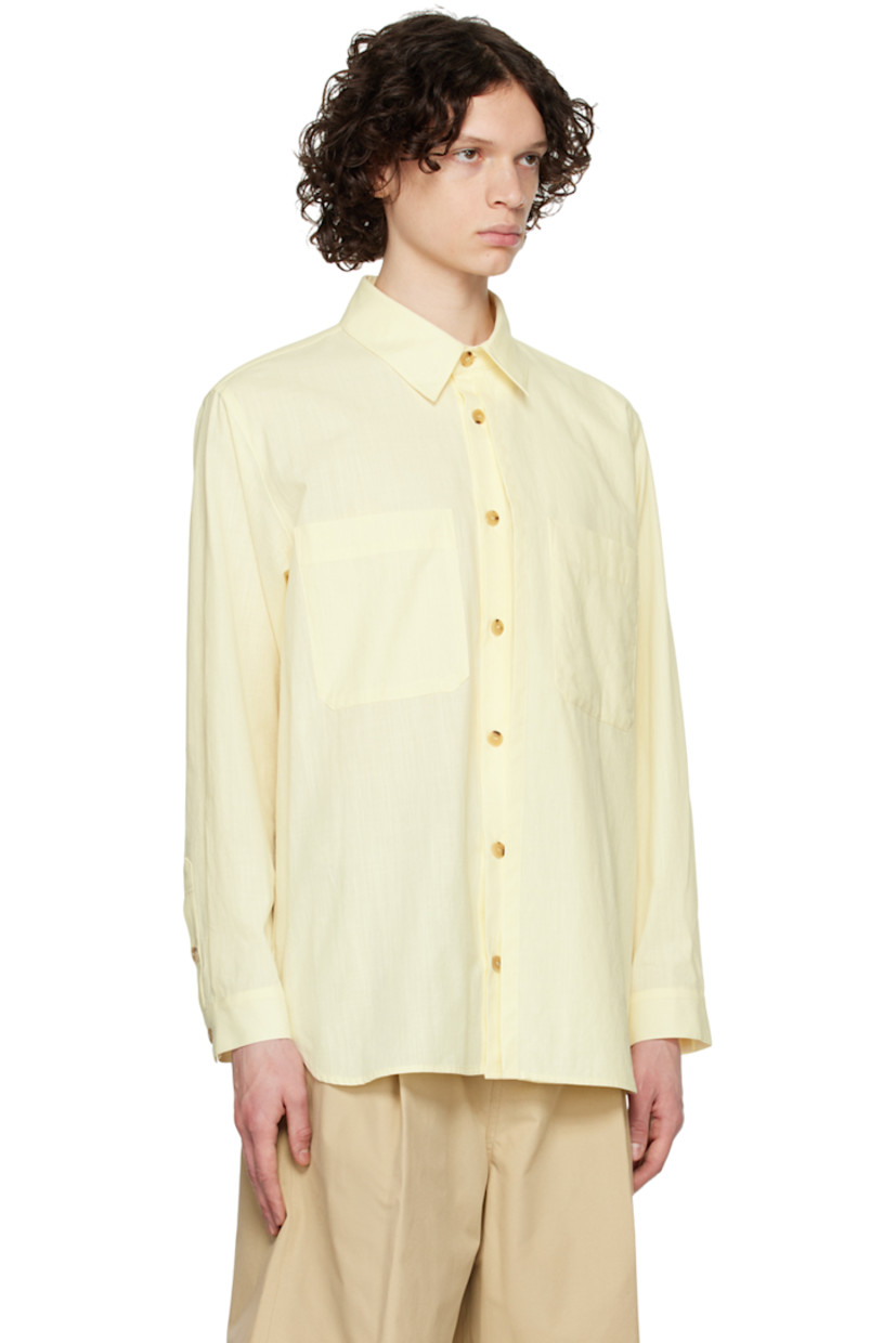 Plain-woven slub cotton shirt.

· Layered construction
· Spread collar
· Button closure
· Patch pocket
· Shirttail hem
· Single-button barrel cuffs
· Logo-engraved horn hardware

Supplier color: Yellow