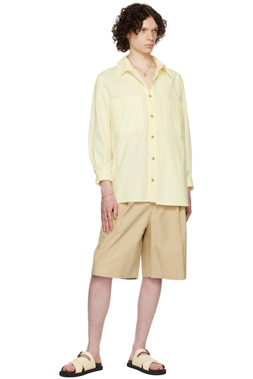 Plain-woven slub cotton shirt.

· Layered construction
· Spread collar
· Button closure
· Patch pocket
· Shirttail hem
· Single-button barrel cuffs
· Logo-engraved horn hardware

Supplier color: Yellow