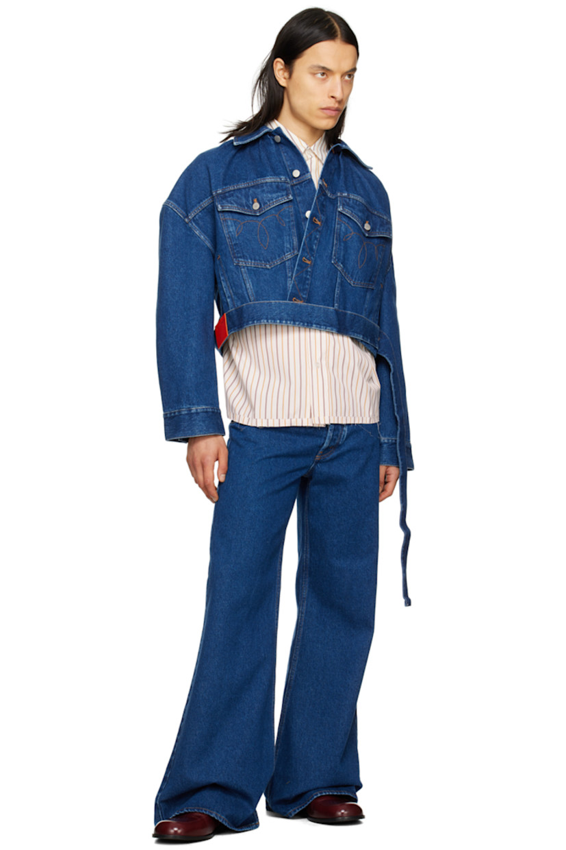 Non-stretch denim jacket. Fading throughout.

· Paneled construction
· Spread collar
· Button closure
· Graphic pattern embroidered at chest
· Flap pockets and welt pockets
· Detachable self-tie belt at cropped hem
· Dropped shoulders
· Single-button barrel cuffs
· Gathering at back collar
· Locker loop at back yoke
· Patent leather logo patches at back hem

Supplier color: Blue