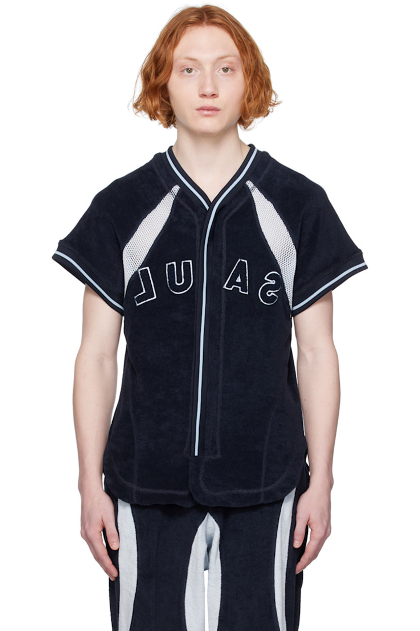 Cotton-blend terrycloth shirt. Mesh trim throughout.

· Paneled construction 
· Rib knit V-neck and cuffs
· Zip closure
· Logo embroidered at front
· Shirttail hem

Supplier color: Navy