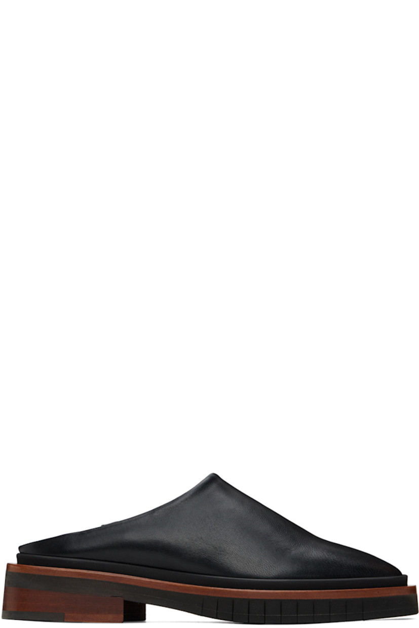 Buffed leather slip-on loafers in black. 

· Square toe
· Logo embossed at buffed leather footbed
· Wood midsole in brown
· Stacked wood heel with rubber injection 
· Treaded rubber outsole
· Heel: H1 in 

Supplier color: Black