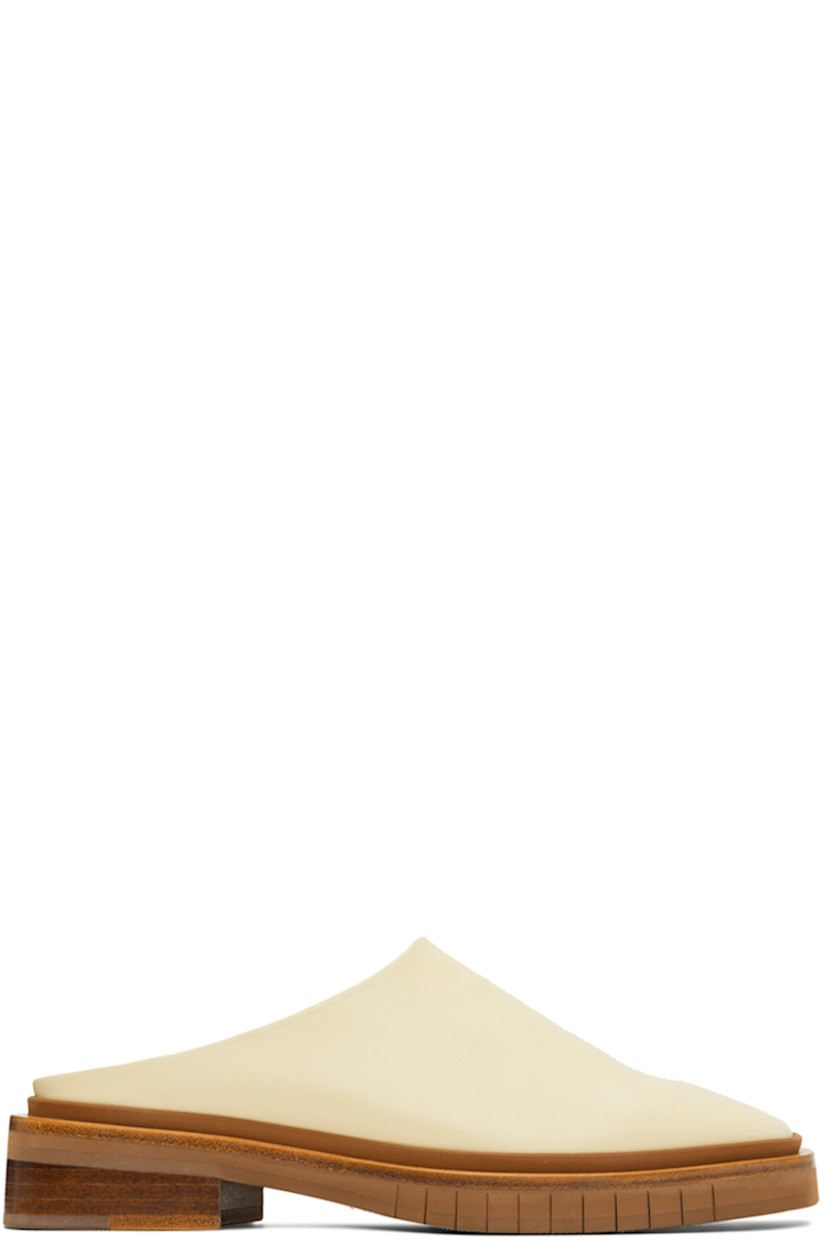 Buffed leather slip-on loafers in off-white. 

· Square toe
· Logo embossed at tan buffed leather footbed
· Wood midsole in brown
· Stacked wood heel with rubber injection 
· Treaded rubber outsole
· Heel: H1 in 

Supplier color: Strawnap
