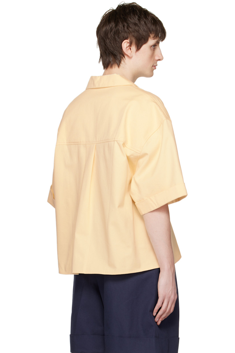 Cotton twill shirt.

· Open spread collar
· Button closure
· Patch pockets 
· Vented side seams
· Rolled edge at cuffs
· Box pleat at back yoke

Supplier color: Ecru