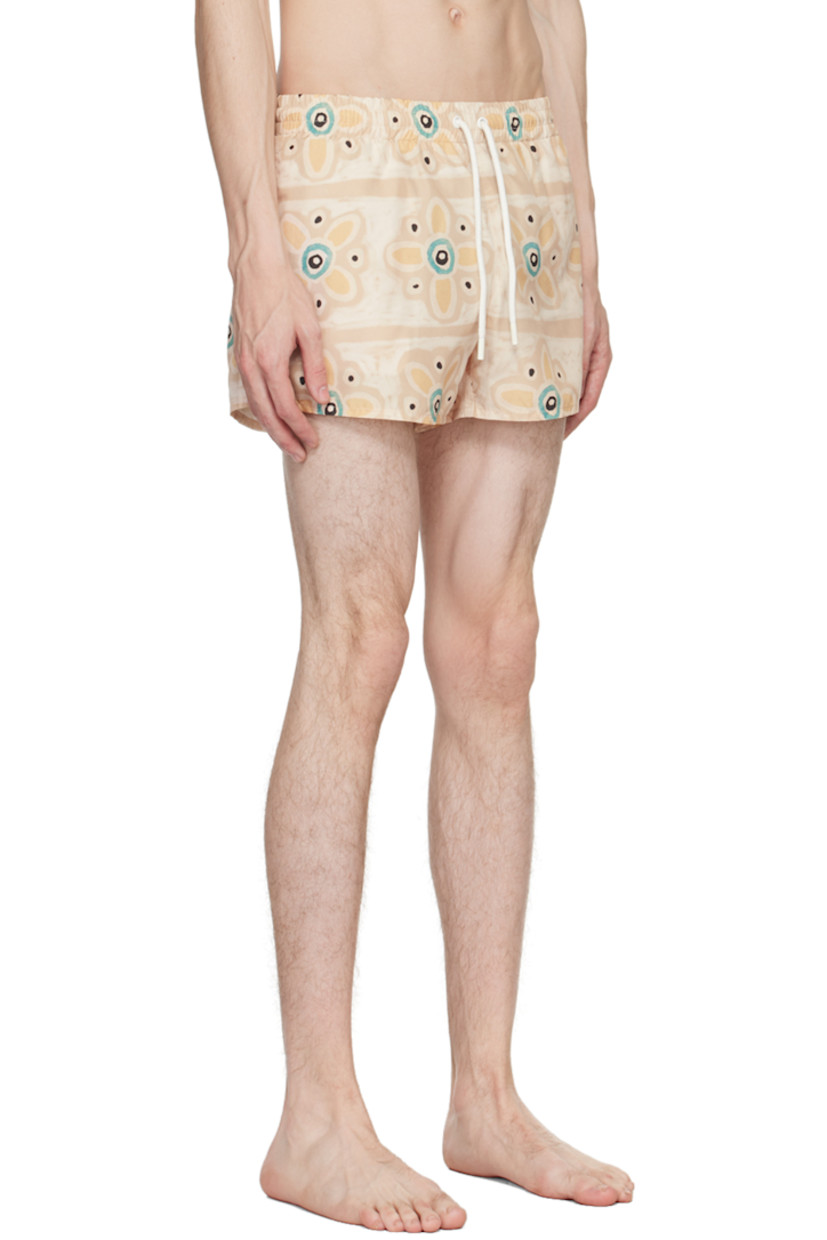 Quick-dry nylon taffeta swim shorts. Graphic pattern printed throughout.

· Drawstring at elasticized waistband
· Two-pocket styling
· Vented outseams
· Partial mesh lining

Supplier color: Beige/Blue