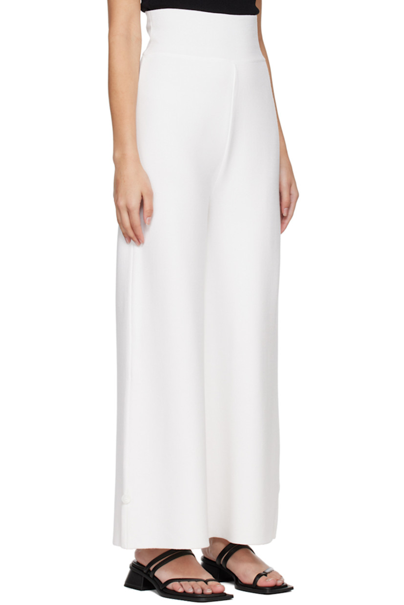 Knit rayon-blend lounge pants.

· Elasticized waistband
· Button accent at cuffs

Supplier color: White