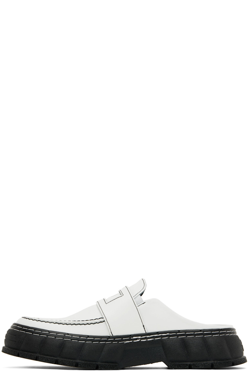 PETA-certified buffed Appleskin™ faux-leather slip-on loafers in white. 

· Round moc toe
· Strap with cut-out at vamp
· Logo printed at vamp and padded footbed
· Elasticized gusset at sides
· Sculptural rubber platform midsole
· Treaded rubber outsole
· Platform: H1.5 in

Supplier color: Contrast