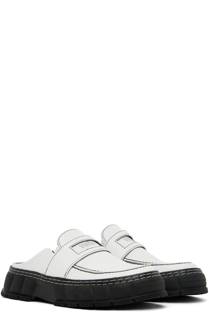 PETA-certified buffed Appleskin™ faux-leather slip-on loafers in white. 

· Round moc toe
· Strap with cut-out at vamp
· Logo printed at vamp and padded footbed
· Elasticized gusset at sides
· Sculptural rubber platform midsole
· Treaded rubber outsole
· Platform: H1.5 in

Supplier color: Contrast