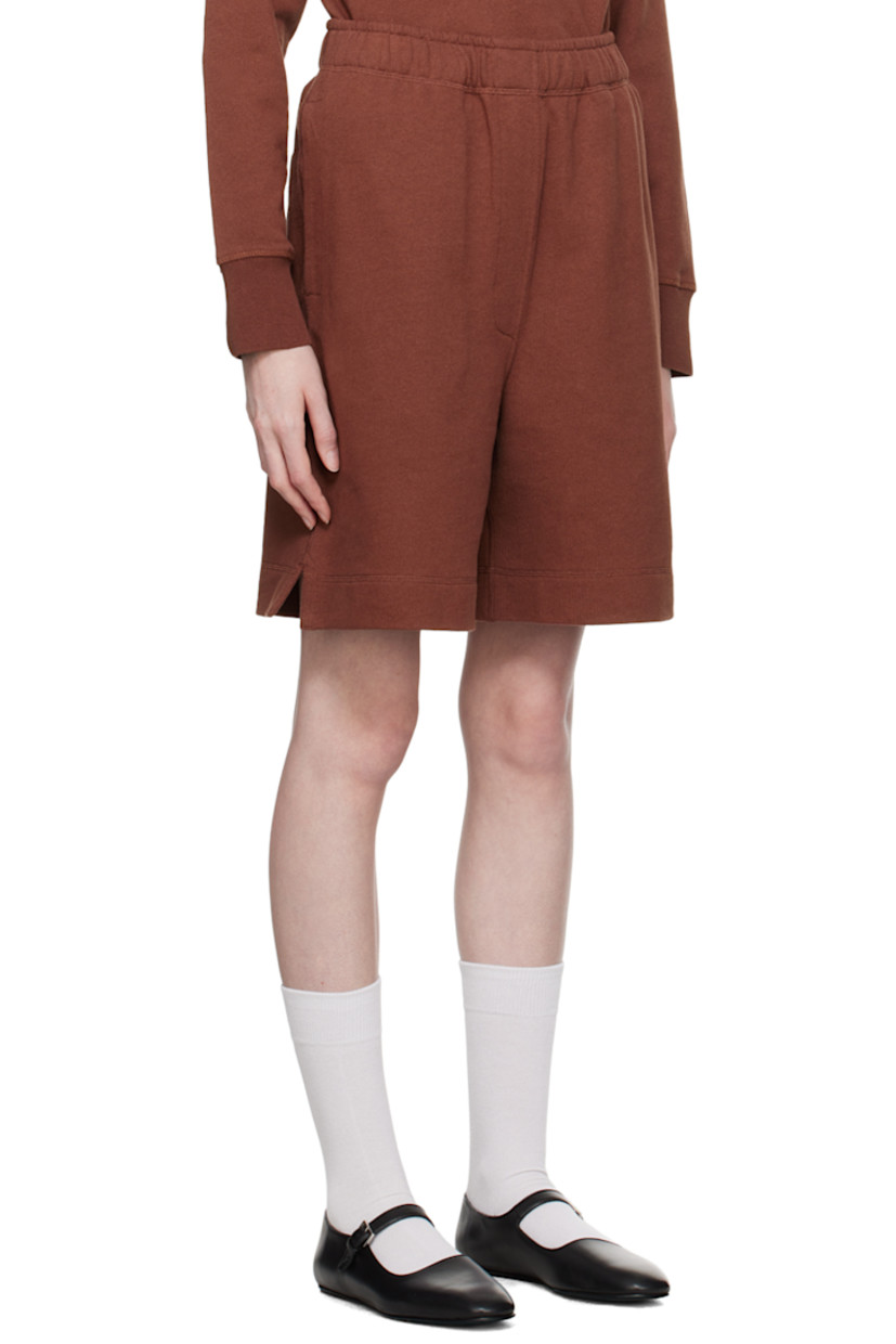 Knit organic cotton shorts.

· Concealed drawstring at elasticized waistband
· Three-pocket styling
· Mock-fly
· Vented cuffs

Supplier color: Burnt sienna