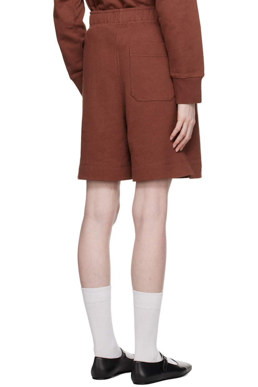 Knit organic cotton shorts.

· Concealed drawstring at elasticized waistband
· Three-pocket styling
· Mock-fly
· Vented cuffs

Supplier color: Burnt sienna