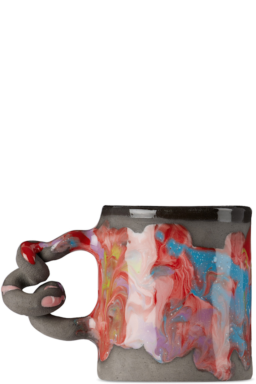 Handcrafted unglazed earthenware mug in black. Hand-painted marbled glaze and paint splatter in multicolor throughout.

· Sculptural handle
· Logo stamp at base
· Glazed interior
· Hand wash recommended
· H3.5" x D3"

Each item is unique. Please note finishings and coloration may vary.

Supplier color: Melted marble/Black