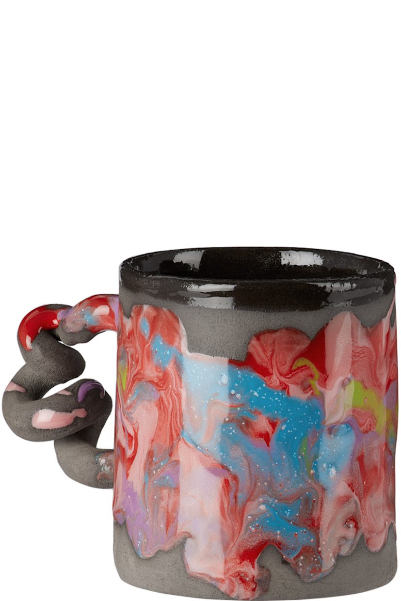 Handcrafted unglazed earthenware mug in black. Hand-painted marbled glaze and paint splatter in multicolor throughout.

· Sculptural handle
· Logo stamp at base
· Glazed interior
· Hand wash recommended
· H3.5" x D3"

Each item is unique. Please note finishings and coloration may vary.

Supplier color: Melted marble/Black
