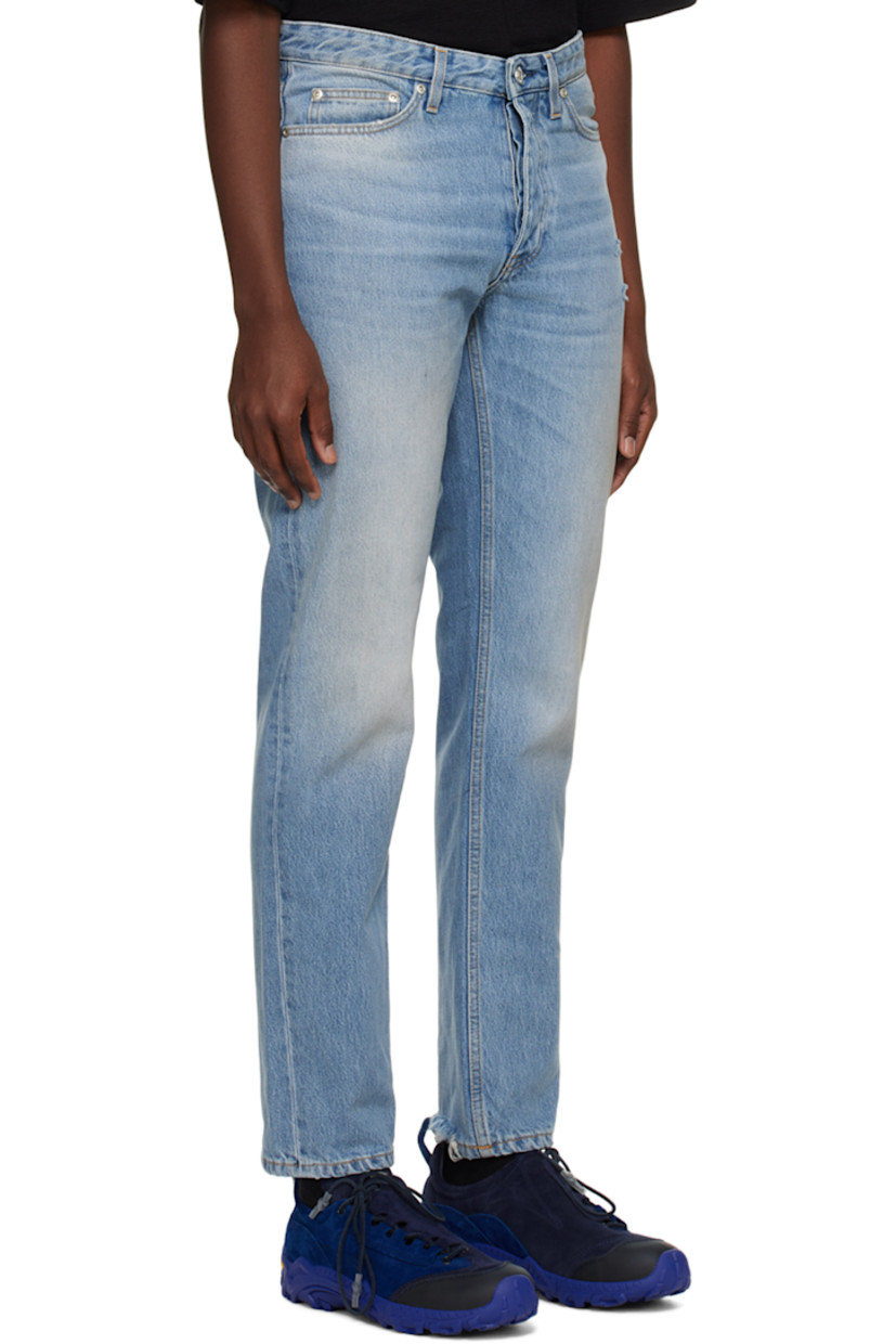 Slim-fit non-stretch denim jeans. Distressing, fading, and whiskering throughout.

· Belt loops
· Five-pocket styling
· Button-fly
· Leather logo patch at back waistband
· Darts at back pockets
· Logo-engraved silver-tone hardware
· Contrast stitching in tan

Supplier color: Worn blue 8