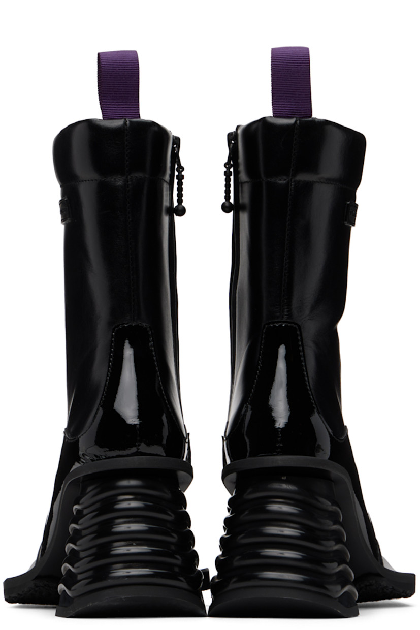 Ankle-high paneled buffed leather and patent leather boots in black. Rubberized logo patch at outer side.

· Square toe
· Webbing pull-loop at padded heel collar
· Zip closure at inner side
· Grained leather lining
· Rubber midsole and block heel
· Treaded rubber outsole
· Heel: H3 in

Supplier color: Black