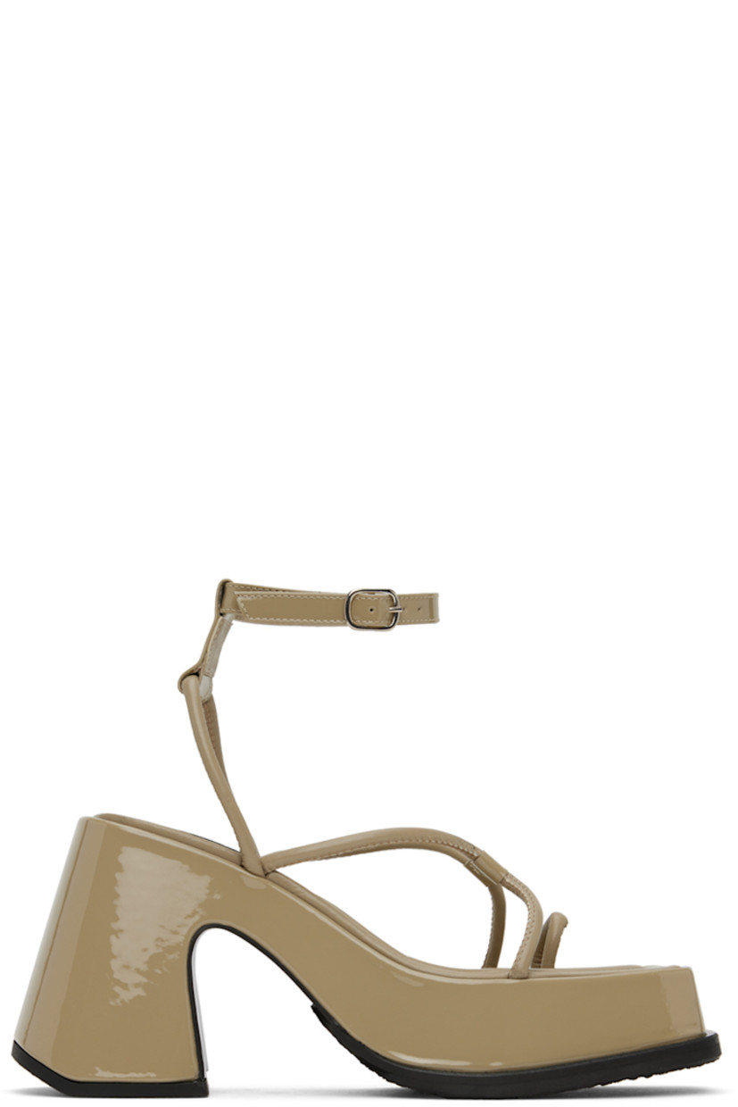 Patent leather heels in beige.

· Open square toe
· Criss-crossing straps at vamp
· Adjustable pin-buckle ankle strap
· Logo patch at padded calfskin footbed
· Covered platform midsole and block heel
· Treaded rubber outsole
· Platform: H1.5 in
· Heel: H3.75 in

Supplier color: Leather elm